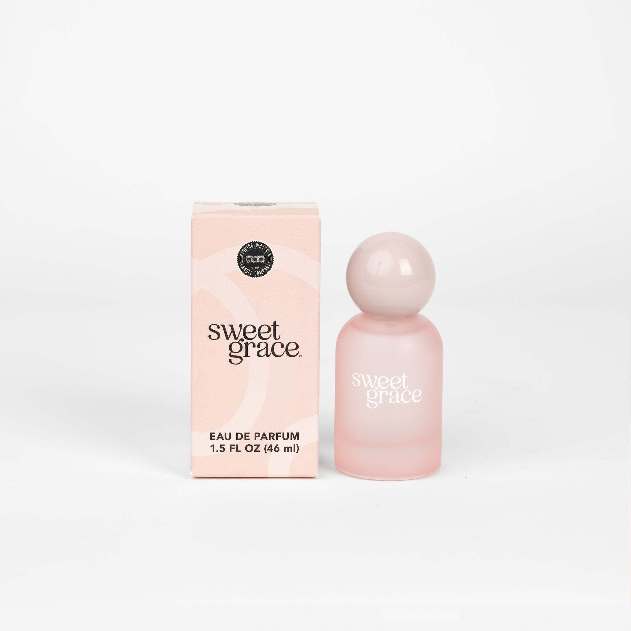 Frosted pink Eau de Parfum bottle with glossy pink spherical cap