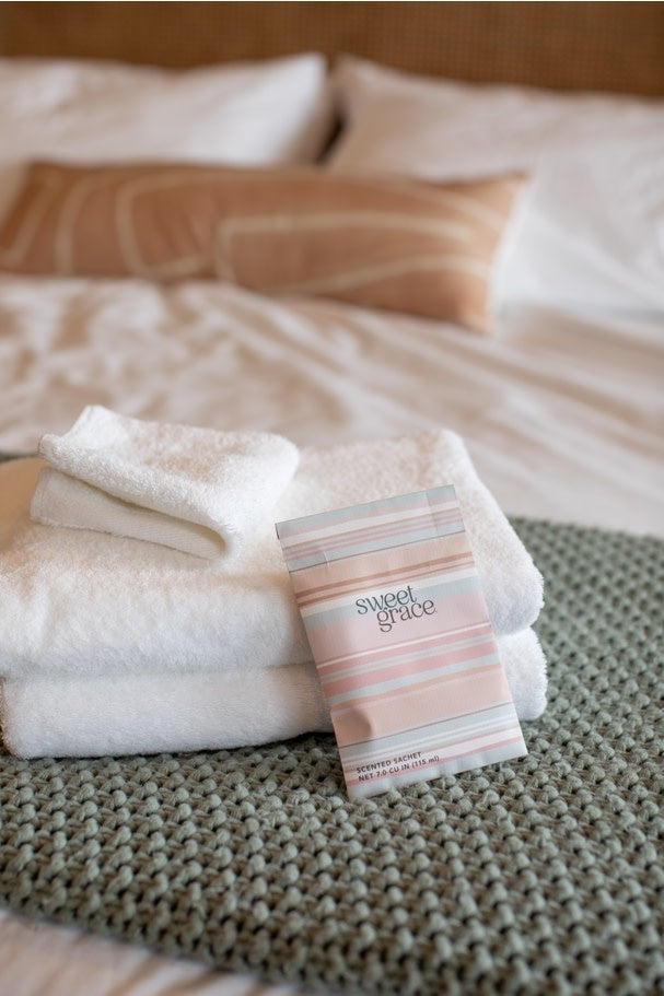 Sweet Grace scented sachet featuring a modern white stripe pattern on pastel packaging.