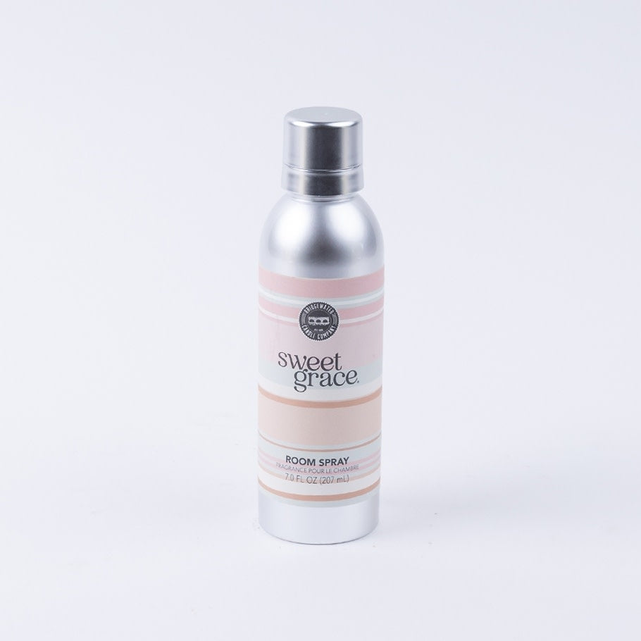 Sweet Grace non-aerosol room spray bottle with a white label featuring exotic passion fruit and patchouli scent details.