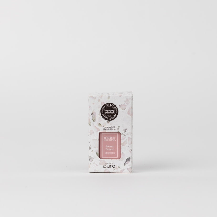 Sweet Grace Pura+Bridgewater fragrance refill bottle with clear glass body showing amber liquid and minimalist label.