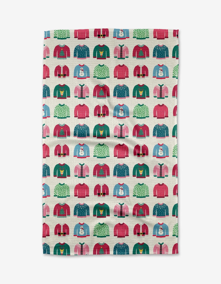 Holiday tea towel with waffle weave construction in red featuring a festive snowman print.