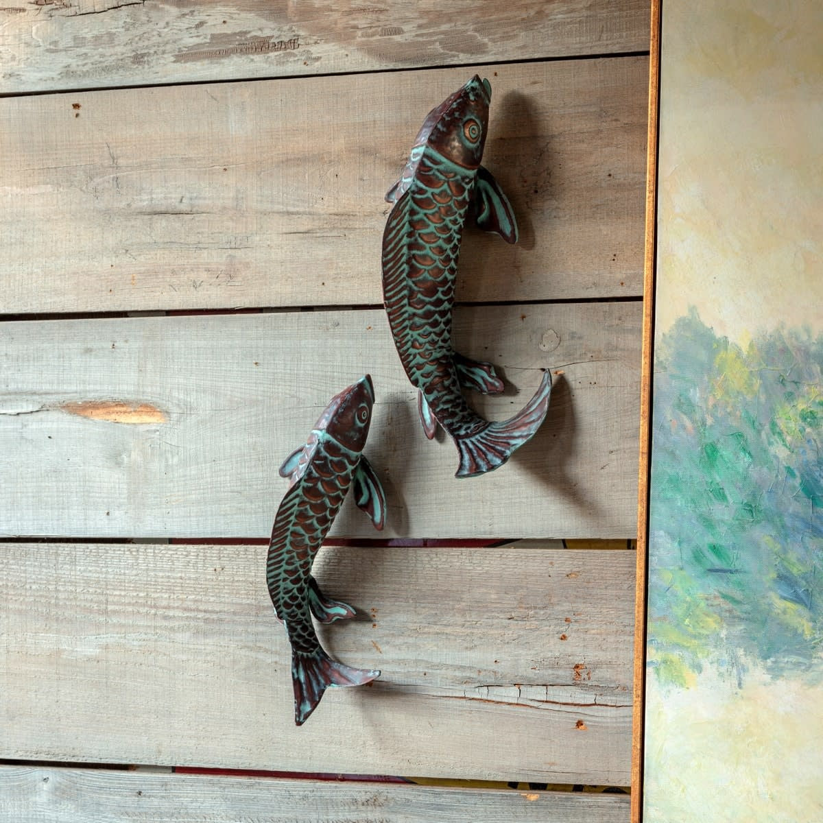 Swimming Koi fish sculpture in verdigris finish with serene flowing silhouette
