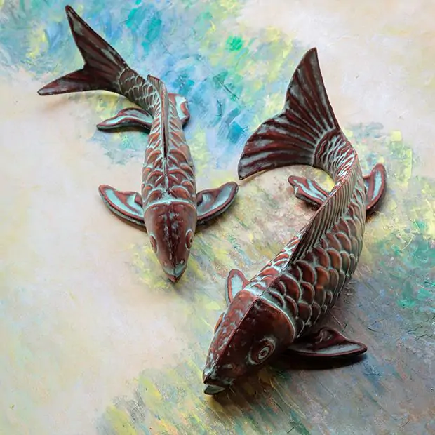 Swimming Koi fish sculpture with verdigris finish, measuring 5.3 inches high and 8.2 inches wide.
