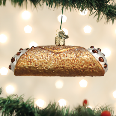 Glass cannoli Christmas ornament with a golden shell and white cream filling with chocolate chips.