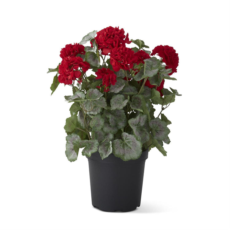 Artificial potted geranium in faux dirt with a black iron wire stand.