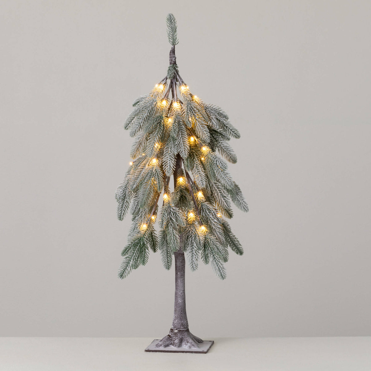 3’ Lit Flocked Droopy Tree with warm white lights and a snow-dusted finish on a square base.