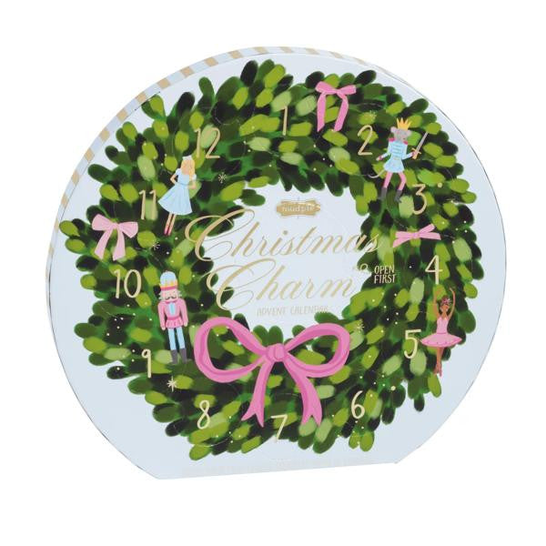 Round Christmas wreath advent calendar with pink bows, nutcracker figures, and numbered doors.