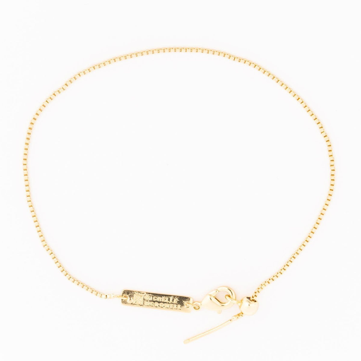Gold-tone Sylvie bracelet featuring a delicate chain with small sparkling gemstone accents.