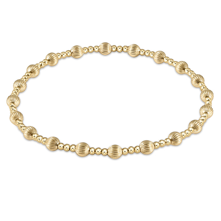 Stackable bracelet featuring 4mm gold-filled dignity beads mixed with smaller textured beads on a chain.