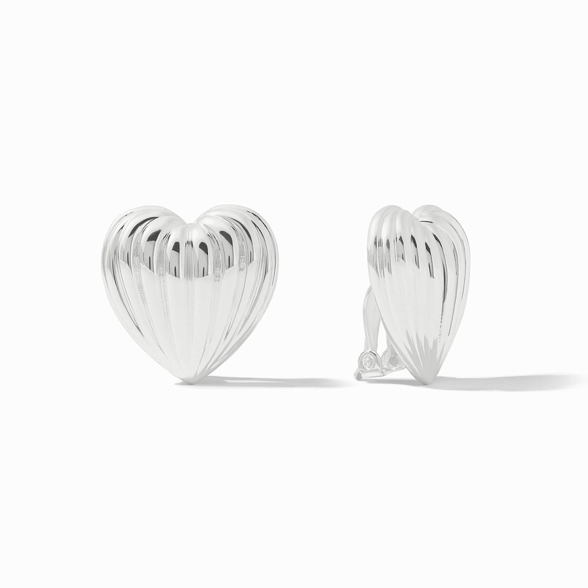Pair of silver puffy heart clip-on earrings with a polished, ribbed texture on a white background.
