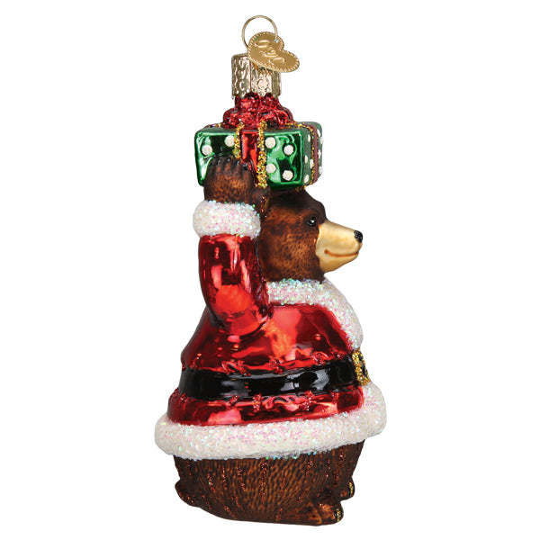 Christmas Bear ornament in red velvet with white trim holding a wrapped gift.