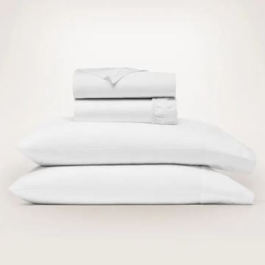 Signature Hemmed Sheet Set in King White, featuring stacked folded sheets and two pillowcases.