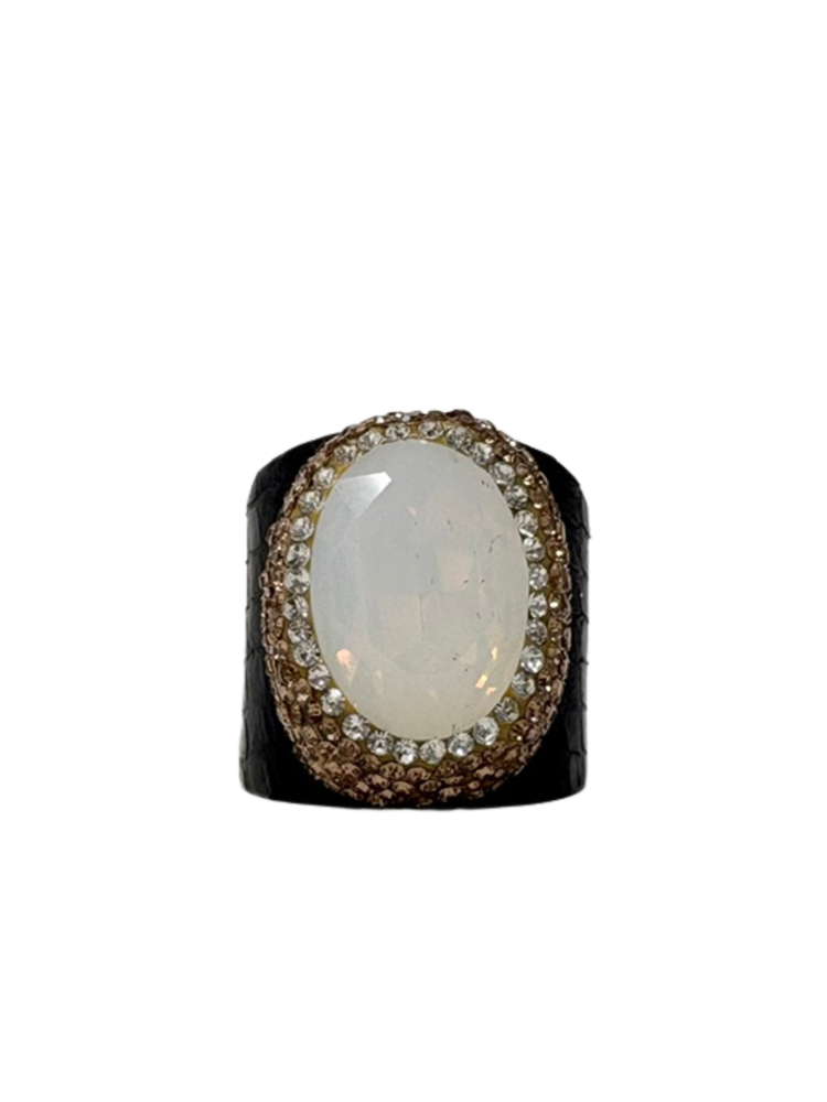 Queen of Sheba Fashion Ring featuring a large oval white stone surrounded by crystals on a black band