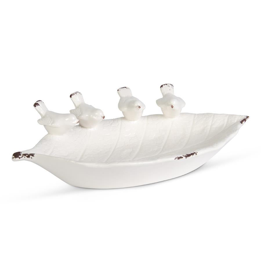 White ceramic leaf-shaped bowl featuring a relief pattern of four song birds.