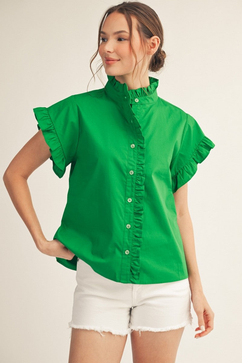 Woman wearing a green Elise Ruffled Detail Woven Top with white denim shorts.