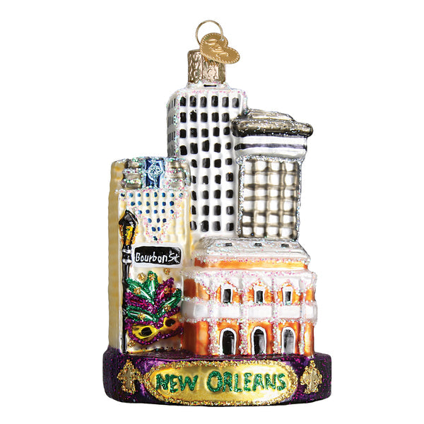Glass New Orleans ornament featuring city buildings, a Mardi Gras mask, and Bourbon St sign.