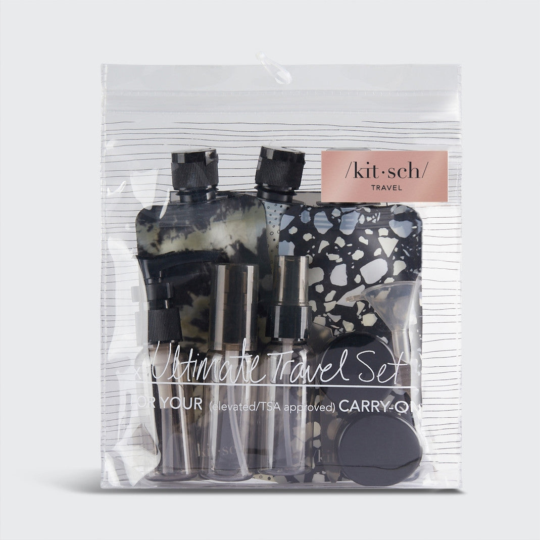 Refillable travel set with spray bottles, pump containers, pouches, jars, funnel, spatula, and pipette in neutral tones.