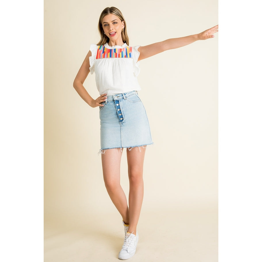 Woven cotton knit top with ruffle sleeves in a light neutral tone.