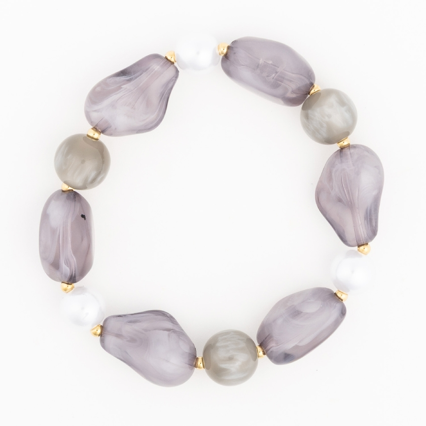 Zoe Bracelet featuring marbled grey, smooth taupe, and white beads with gold spacers.