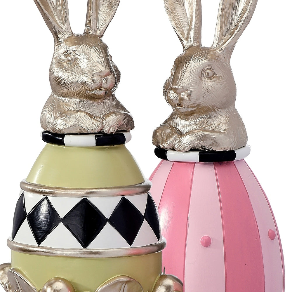 Resin garden bunny egg topiary with a white shell-like finish standing on a green stem.