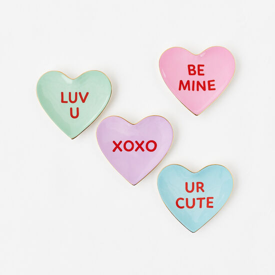Ceramic trinket dish shaped like a conversation heart candy with red text on white.
