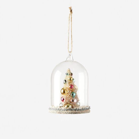Glass dome ornament featuring a miniature Christmas tree inside.