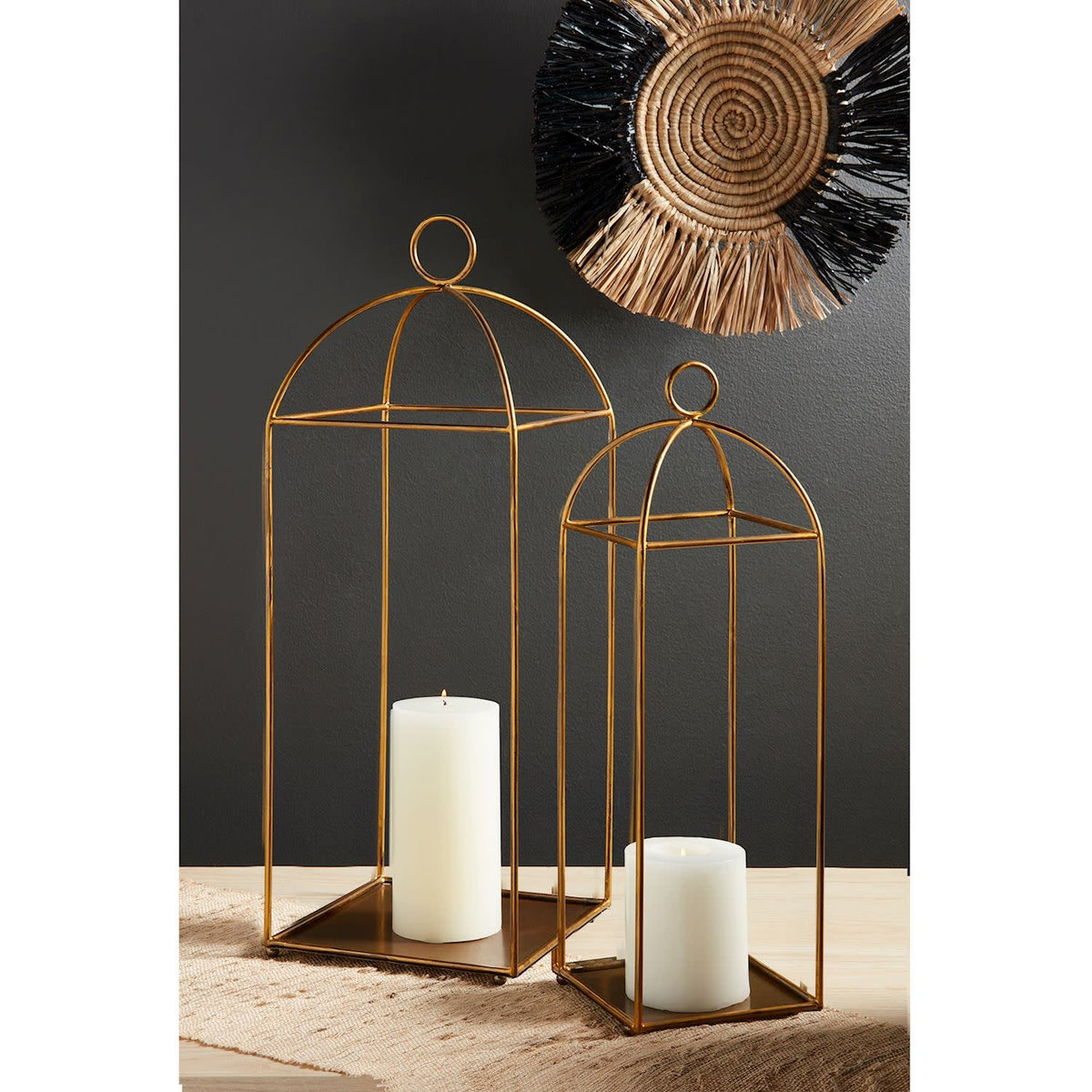 Tall brass lantern with a cylindrical metal body and openwork geometric pattern.