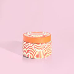 Volcano Tangerine printed travel tin candle with bright tropical fruit pattern on a blue background