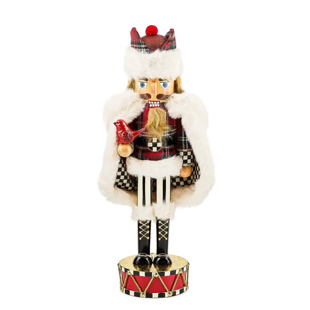 Wooden nutcracker with tartan fabric accents in cardinal red.