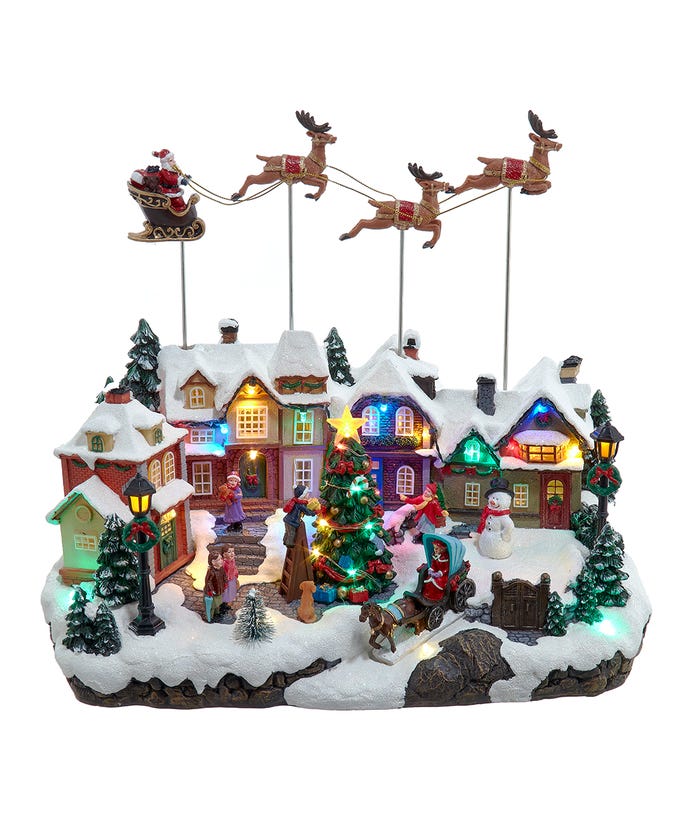 Musical LED Christmas village scene with Santa's sleigh, reindeer, and a decorated tree.