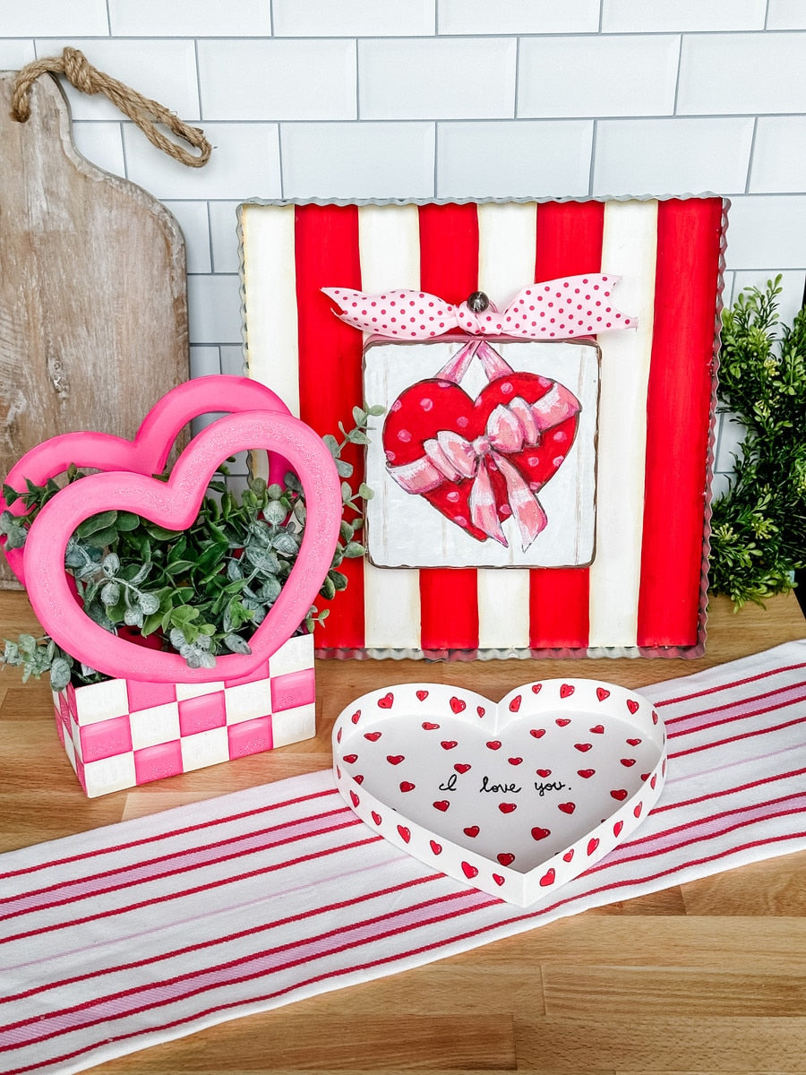 Heart-shaped box with a hinged lid featuring a subtle textured pattern.