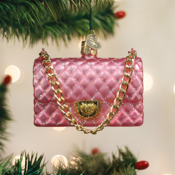 Pink quilted purse Christmas ornament with a gold chain strap and heart-shaped clasp.