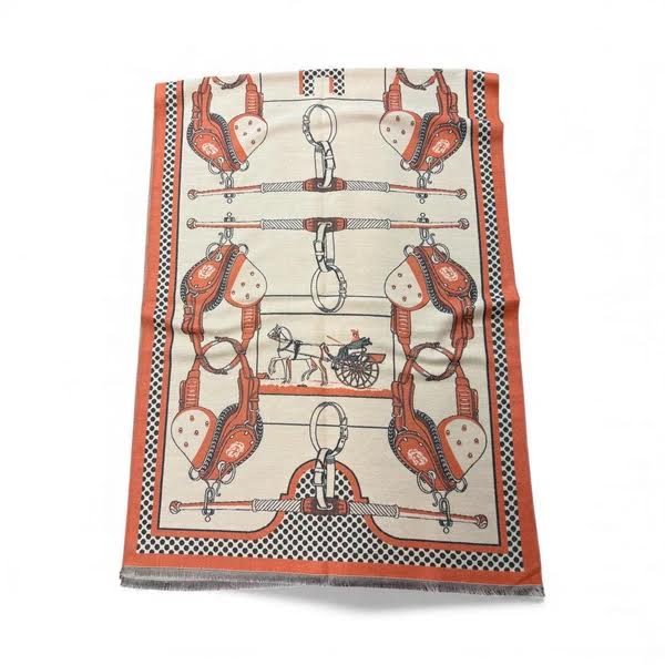 Reversible wrap scarf in cream and orange with a horse-drawn carriage and equestrian harness print.