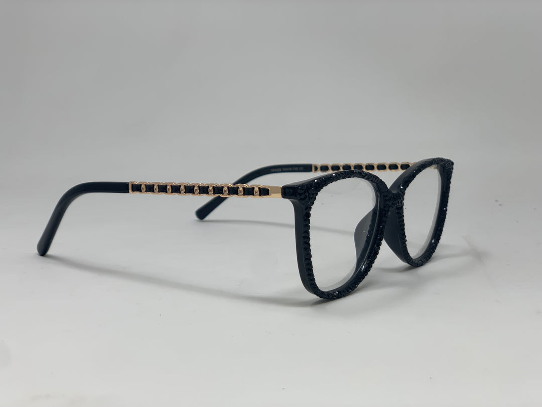 Black rhinestone reading glasses with gold chain-link detail on the temples.