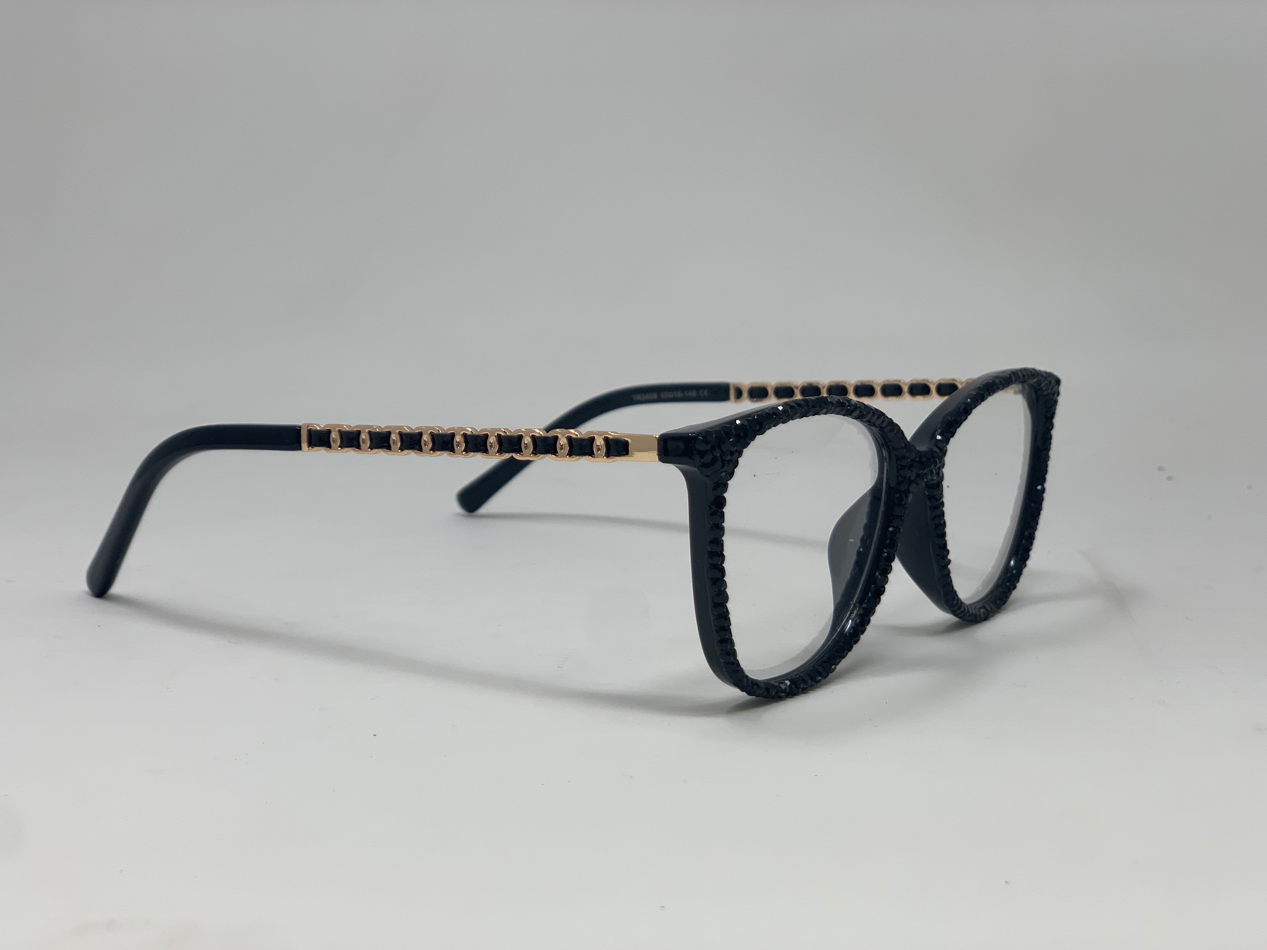Black rhinestone reading glasses with gold chain-link detail on the temples.