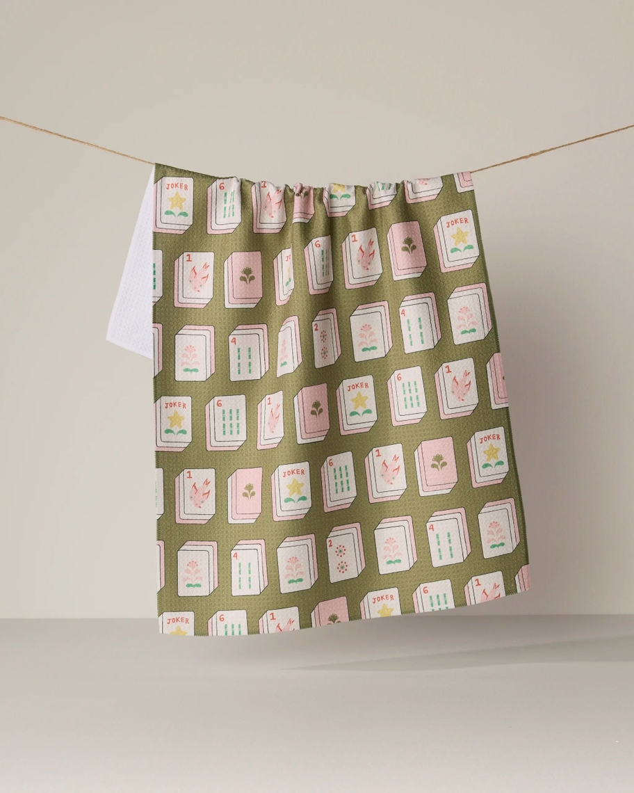 Everyday Tea Towel with an olive green mahjong tile pattern hanging on a clothesline.