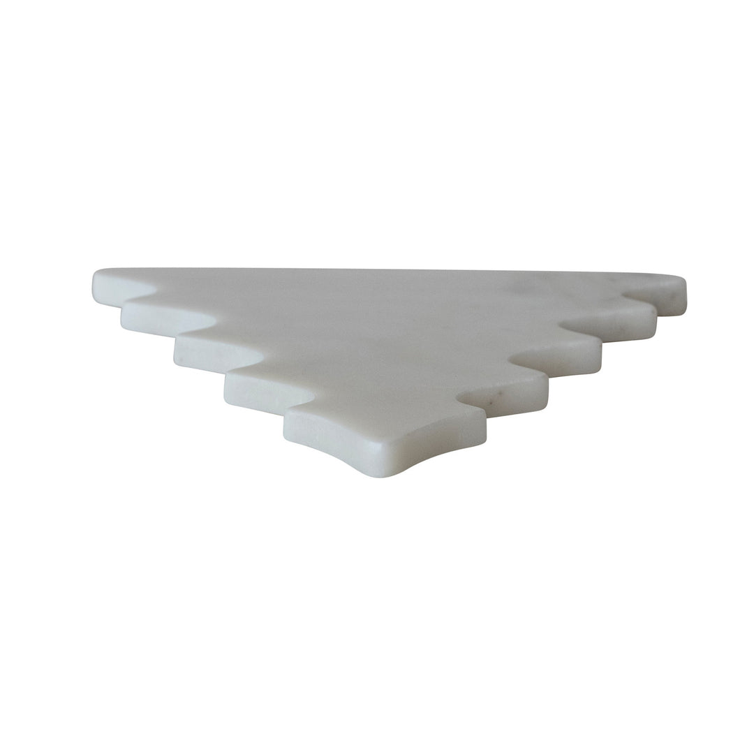 White marble tree-shaped trivet or serving board with tiered edges on a white background.