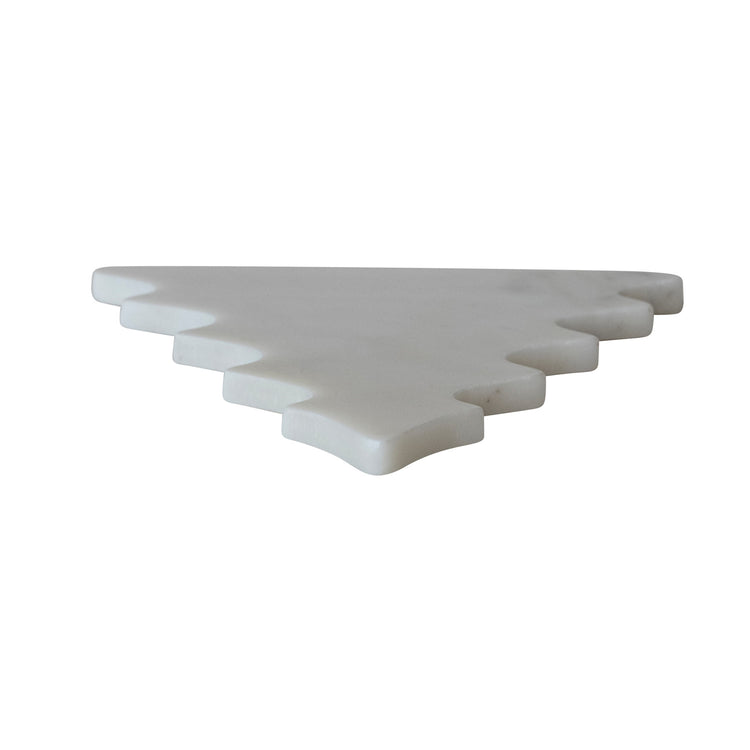 White marble tree-shaped trivet or serving board with tiered edges on a white background.
