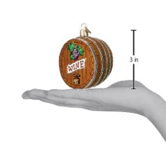 3-inch wine barrel Christmas ornament with grape design, shown held in a hand for scale.