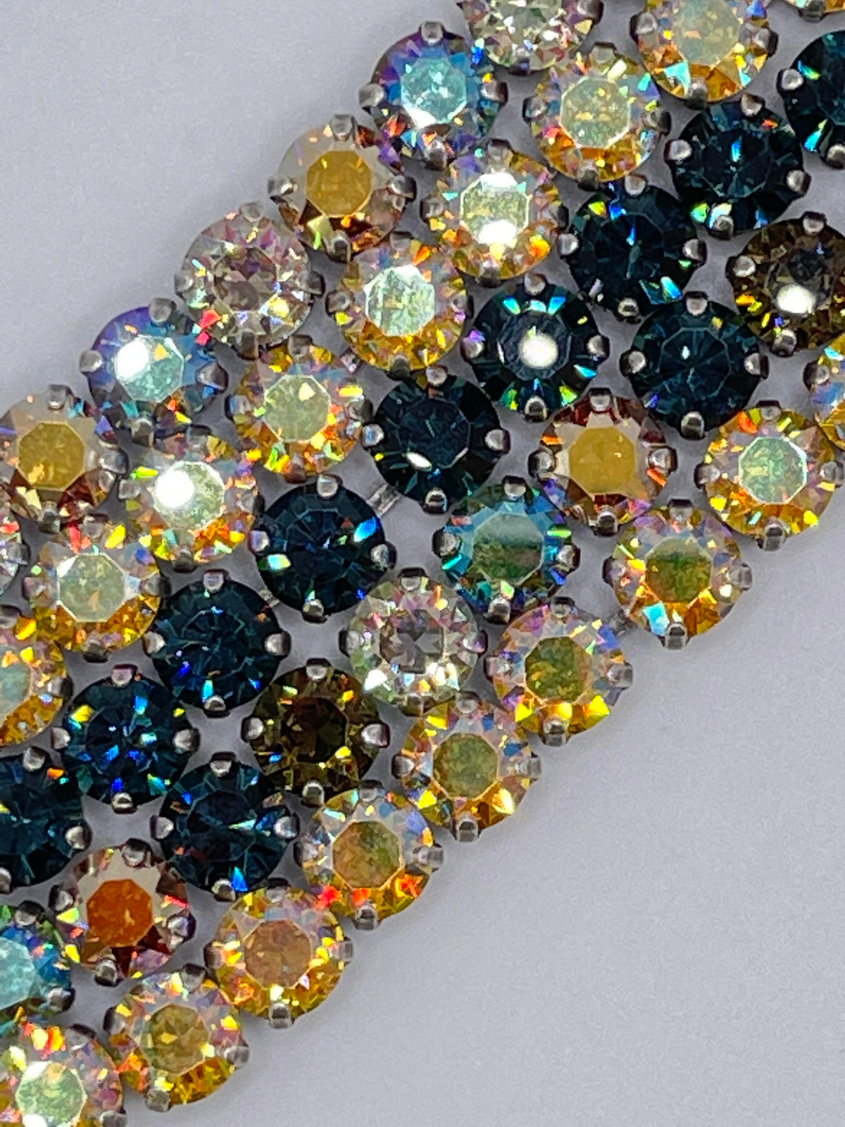 Close-up of the Istanbul Classic Bracelet featuring dark blue, brown, and gold faceted crystals.