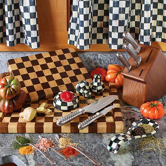 Handmade checkered acacia wood chopping board with rubberwood accents.