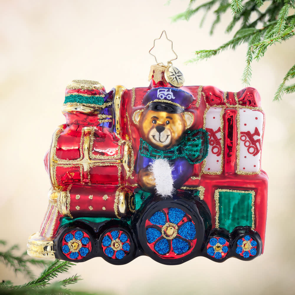 Teddy's Gift Express: a small wooden train figurine with red festive decorations and presents.