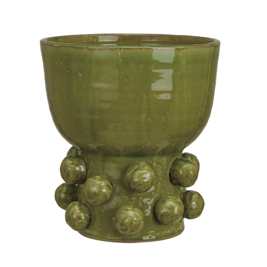 Round terra-cotta footed vase with hobnail texture in reactive green glaze.