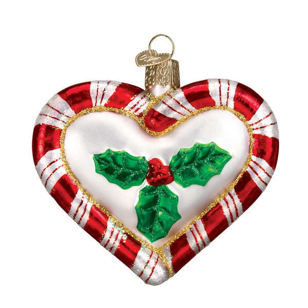 Red heart-shaped peppermint ornament with white speckled candy cane pattern.