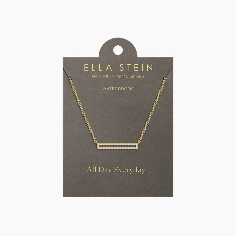 Gold bar pendant necklace with diamonds on a grey display card labeled Ella Stein.