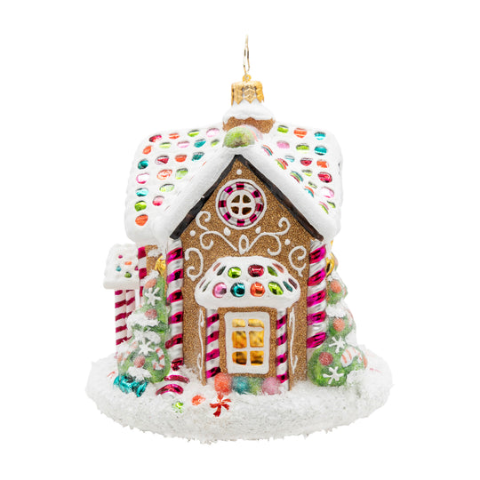 Gingerbread house Christmas ornament with snowy roof, candy accents, and glittery details.