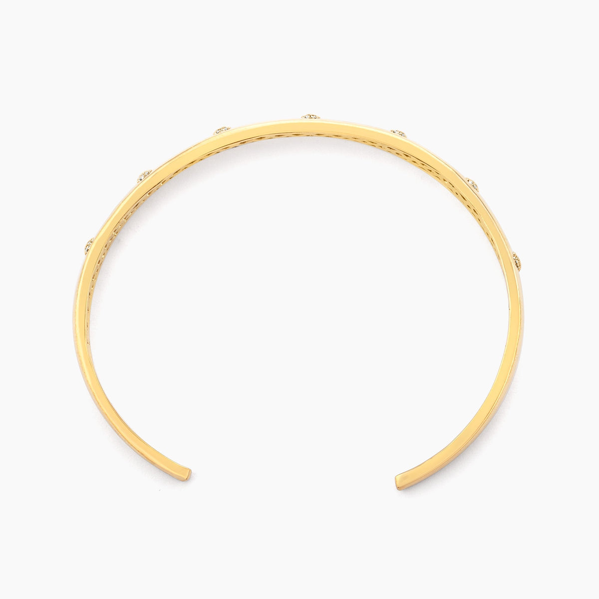 Top view of a gold-plated Waterproof Lucky 7 Cuff Bracelet with seven small diamond accents.