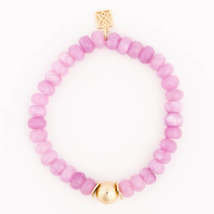 Paloma Pink beaded bracelet with a gold charm and a central gold bead.