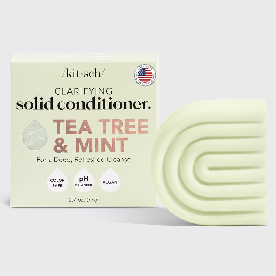 Tea Tree & Mint Clarifying Solid Conditioner bar in a natural off-white color with visible botanical speckles.