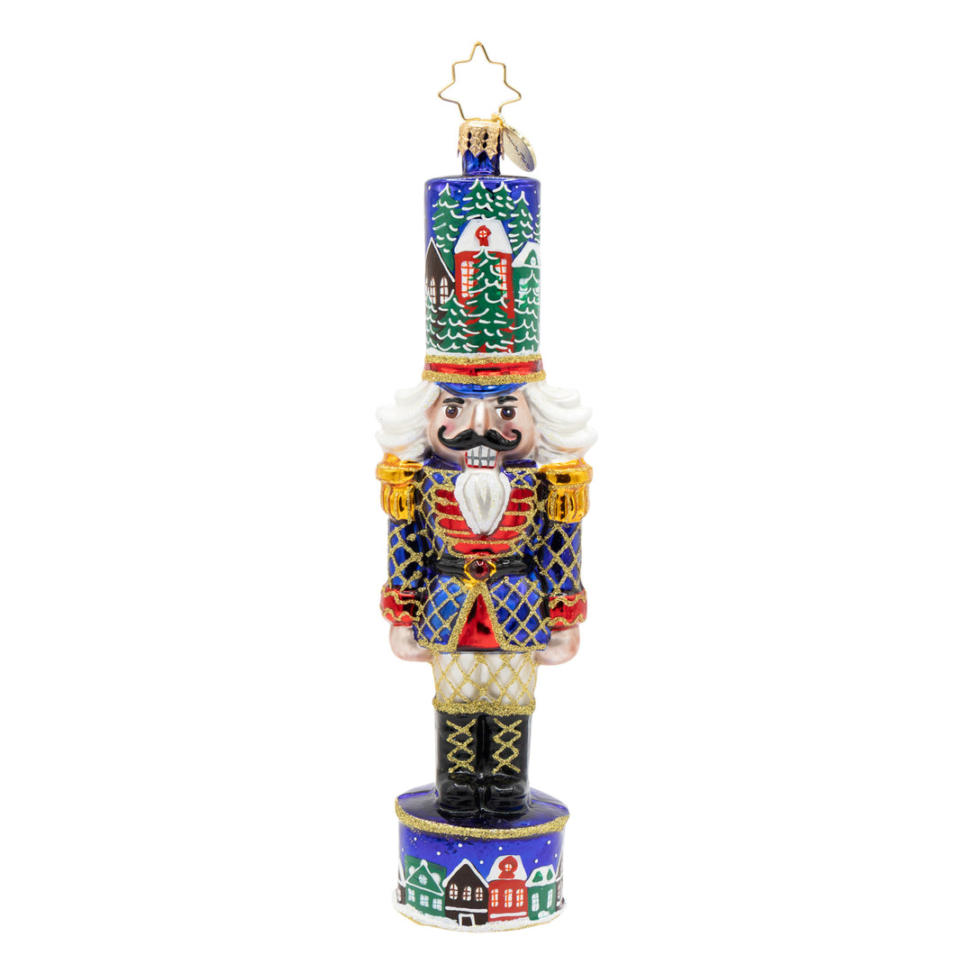 Christmas Sentinel nutcracker ornament in royal blue with a snowy village scene on hat and base.